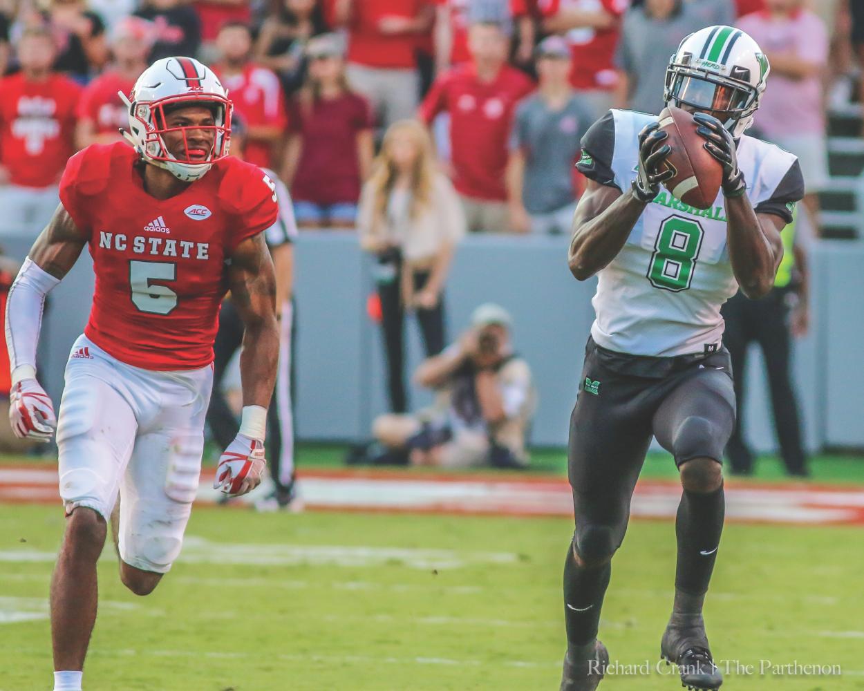 Marshall redshirt junior wide receiver Tyre Brady (right) breaks away from NC State cornerback Johnathan Alston during the Thundering Herd’s 37-20 loss to the Wolfpack in Raleigh, N.C. at Carter-Finley Stadium.