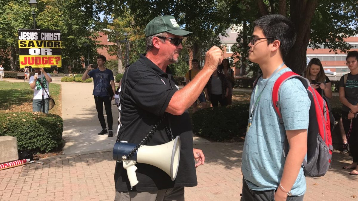 Freshman computer science major Lynne Thompson (right) confronts open-air preacher John McGlone over his method of envangelism Monday at the Memorial Student Center plaza. A Christian, Thompson disagreed with how McGlone was choosing to spread the teachings of the religion.