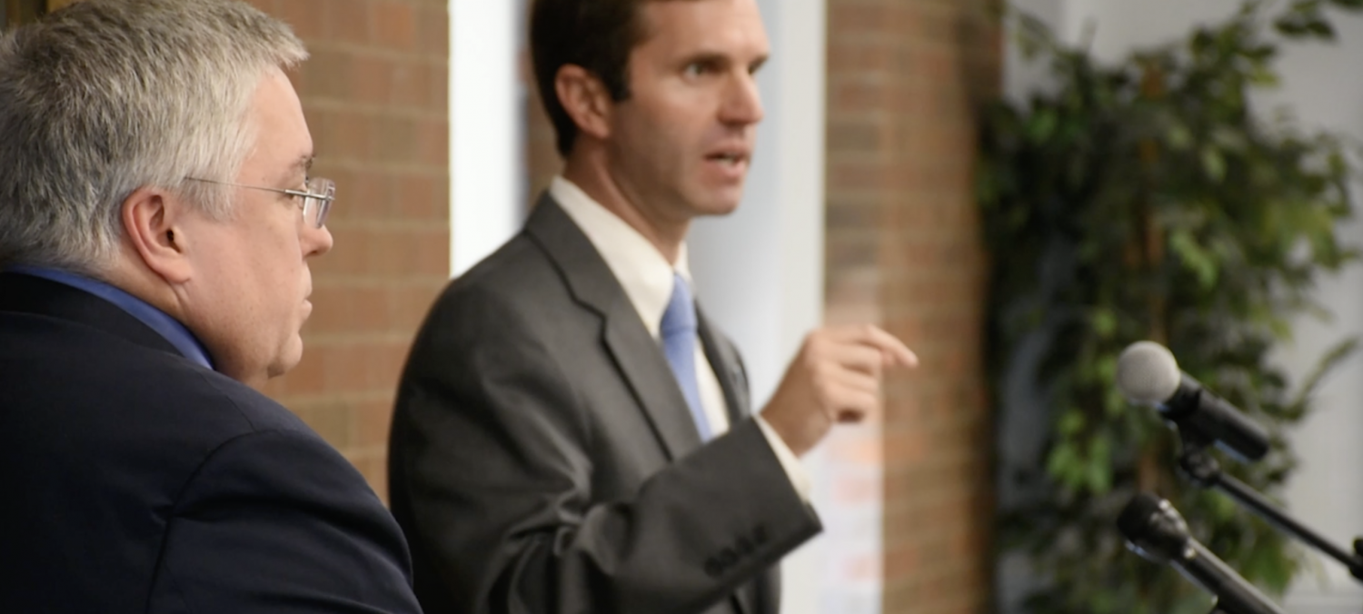 West Virginia Attorney General Patrick Morrisey (left) and Kentucky Attorney General Andy Beshear discuss Monday a 36-state initiative for health insurance companies to consider alternatives to opioid prescriptions in the Shawkey Room of the Memorial Student Center.