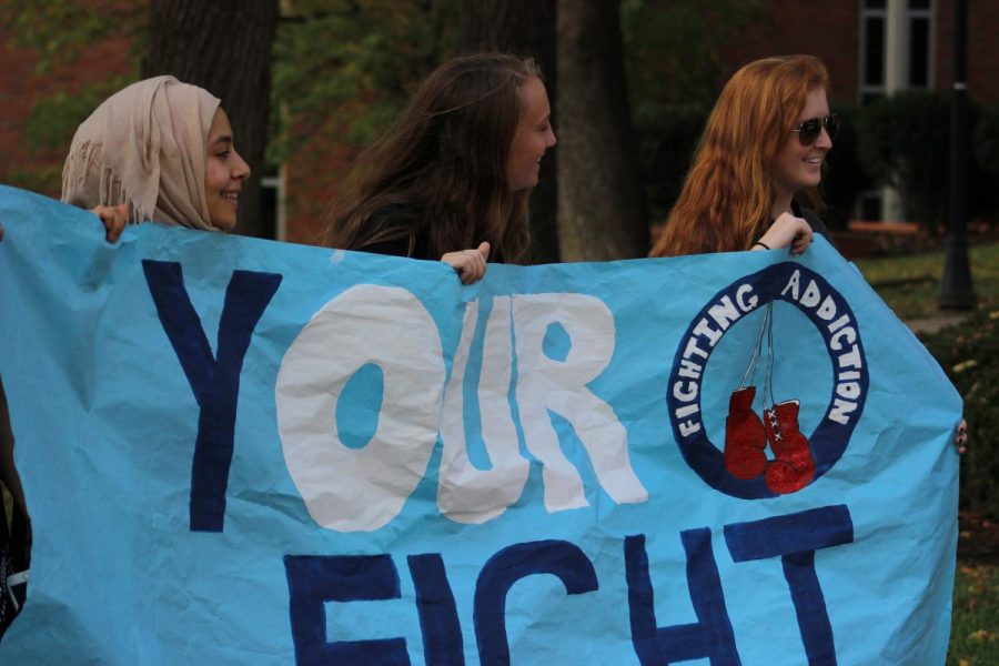 Members of the Fighting Addiction club participate in Marshall’s Unity Walk Monday.