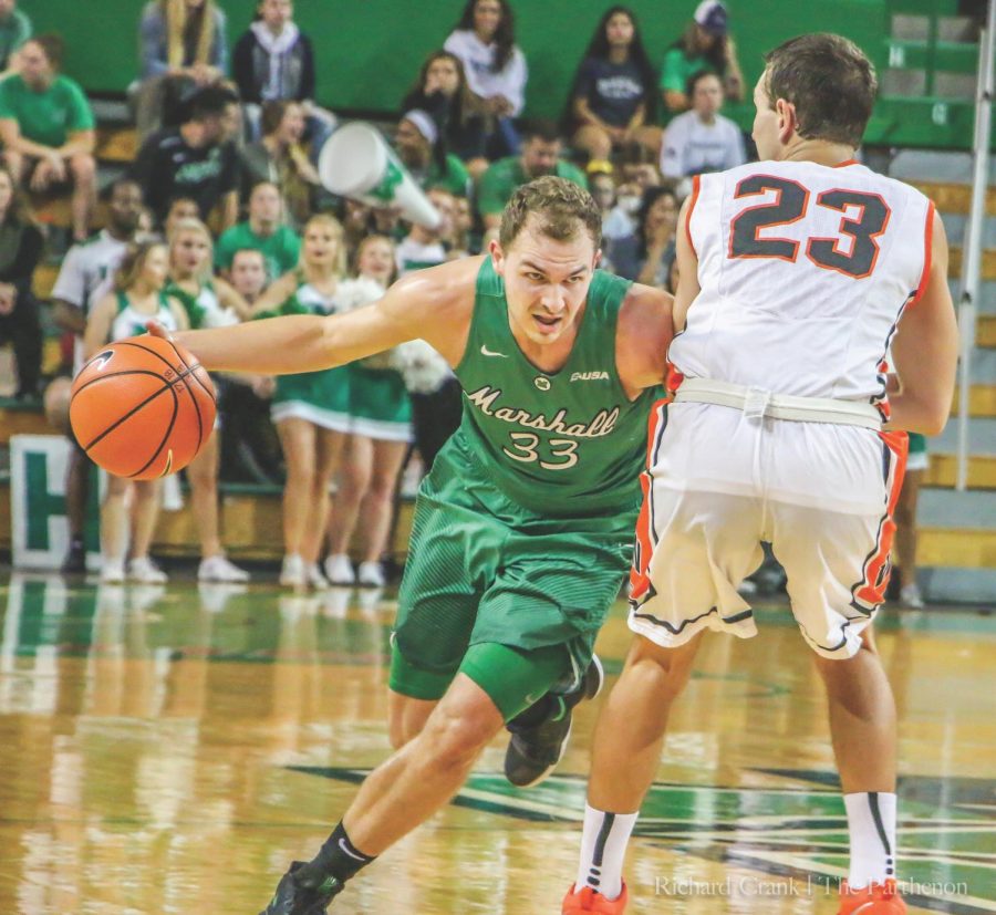 Marshall men’s basketball guard Jon Elmore drives past his defender from West Virginia Wesleyan in the Thundering Herd’s 95-76 exhibition win on Sunday in the Cam Henderson Center.