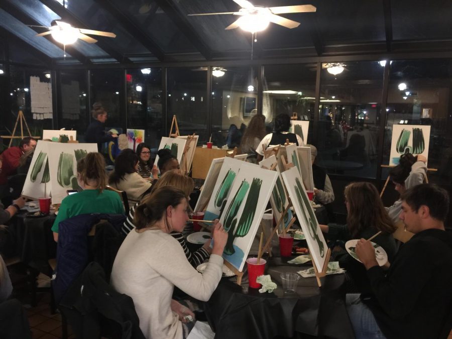 Students paint the Memorial Fountain at Mondays Campus Activity Board-sponsored Paint and Sip.