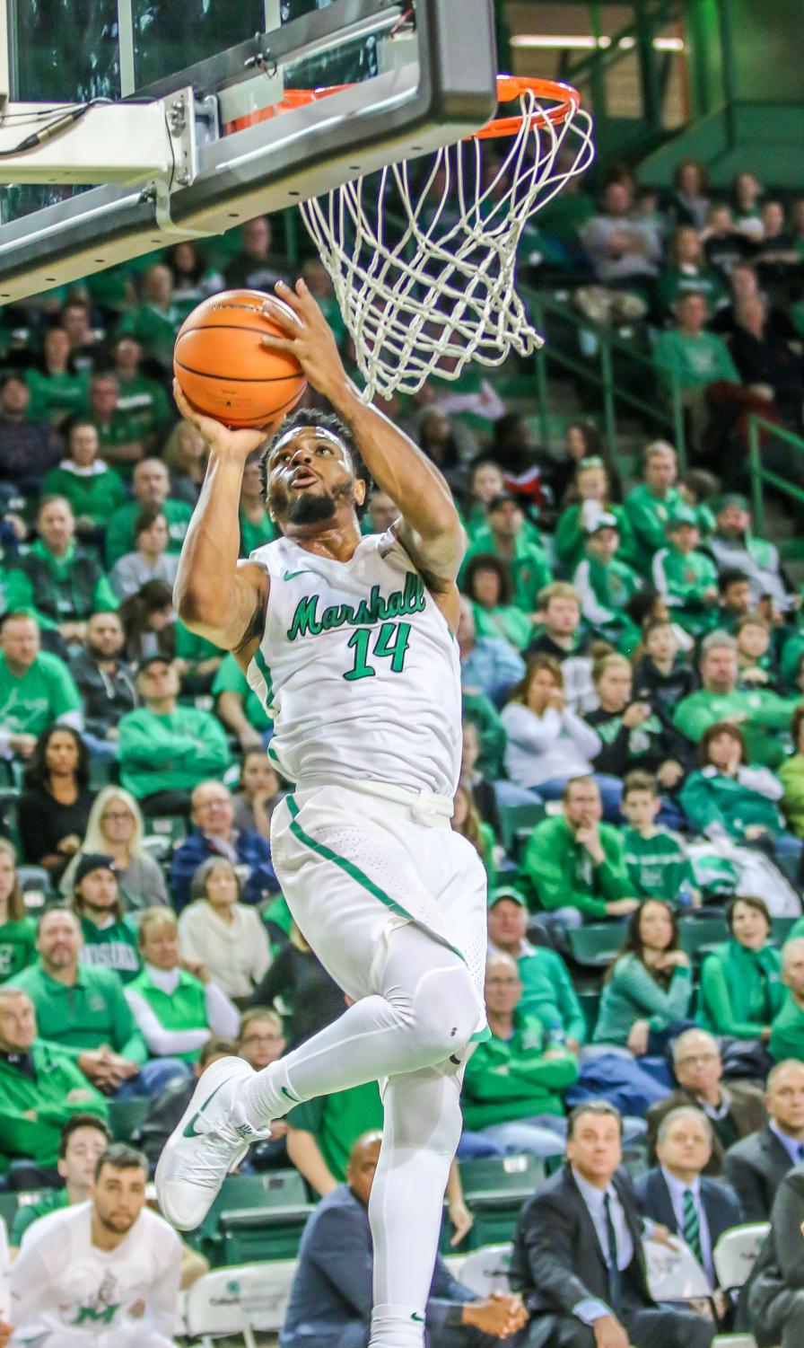 C.J. Burks drives for a layup against WKU. Burks had a game-high 24 points in Marshall's last contest against ODU.