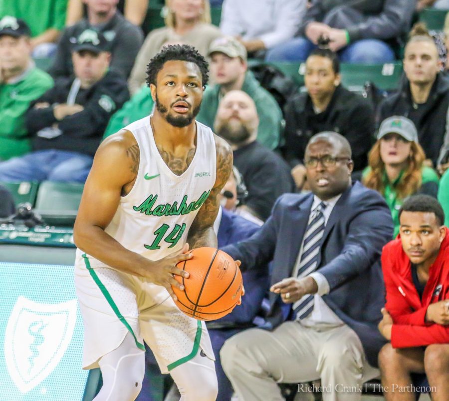 Marshall guard C.J. Burks (14) sets his feet for a shot attempt. Burks is second on the team in scoring behind Jon Elmore. 