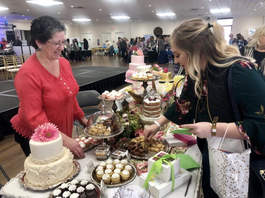Chesney Poole, a newly engaged Marshall University sophomore, talking to Susan Hicks of Suzcatering in Barboursville. Poole said the Bridal Expo allowed her to easily picture her wedding as a whole.