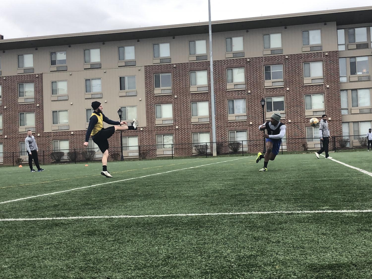 Members of the Alpha Tau Omega and Marshall Recreation Center staff members playing soccer on the Marshall Rec fields outside of freshman south dorms.