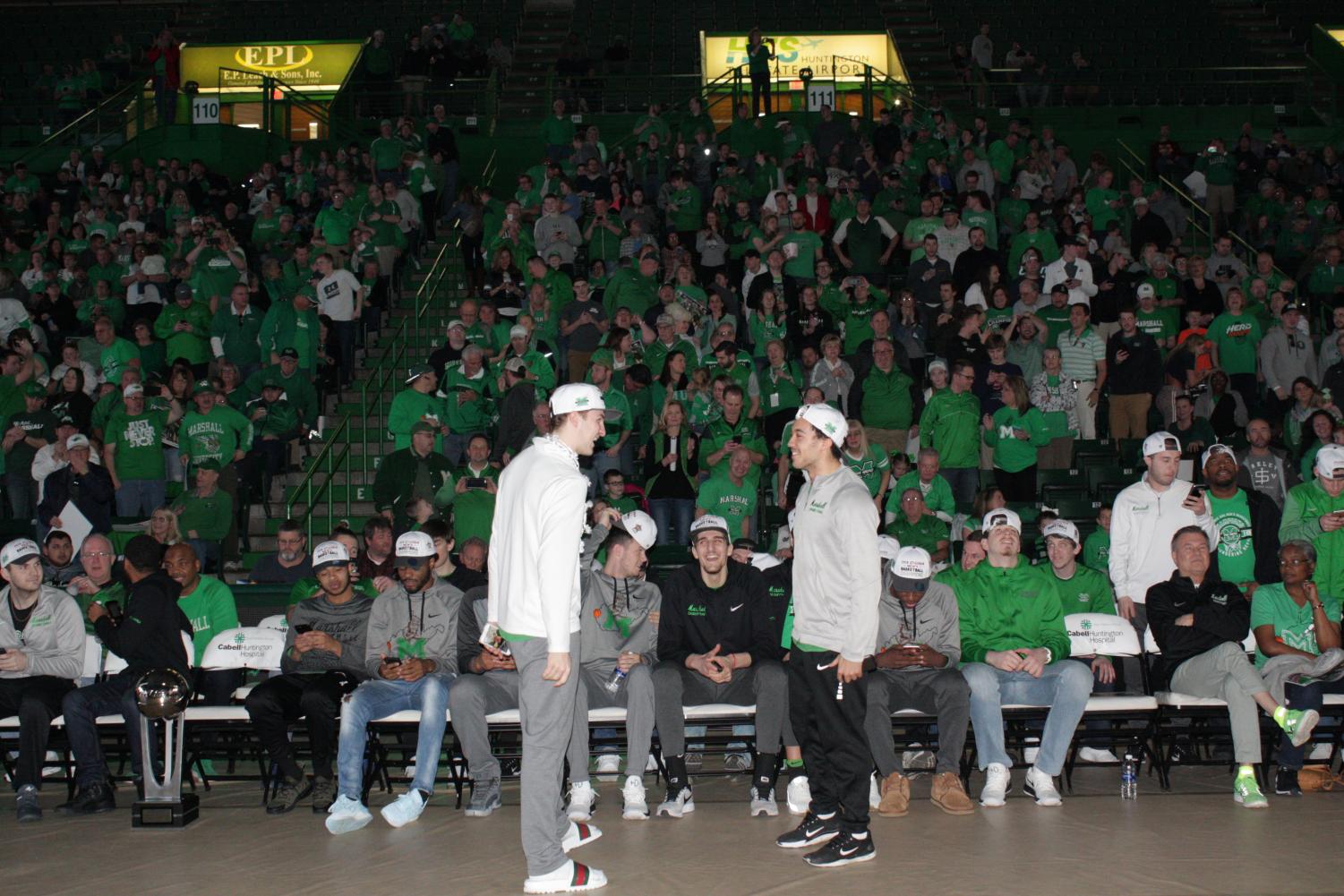 Junior guard Jon Elmore and freshman guard Jarrod West celebrate during Marshall's Selection Sunday viewing party.