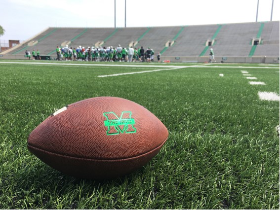 Marshall football proceeds with one of its with spring practices last season in the background of an official Marshall practice ball. 