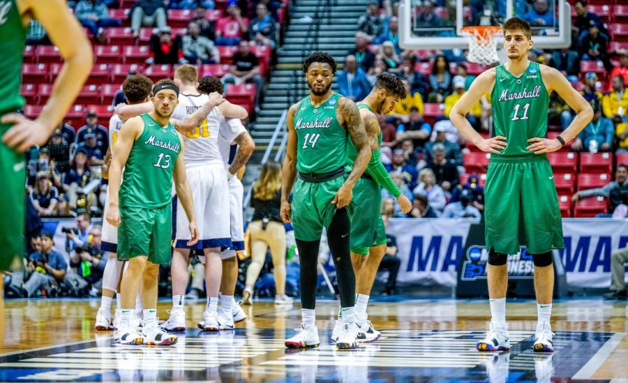 Freshman guard Jarrod West, junior guard C.J. Burks and junior forward Ajdin Penava stand at mid-court as Jon Elmore takes free-throws after a WVU technical foul.