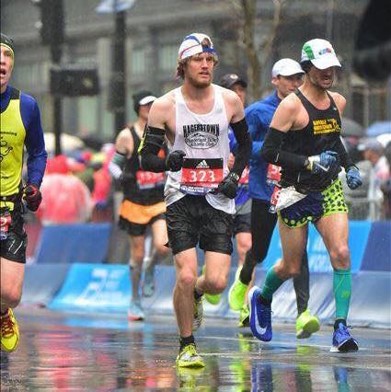 Caleb Bowen in Bib, 323 running in the 2018 Boston Marathon Monday. Bowen is an assistant coach for the Marshall Thundering Herd track and field team. 