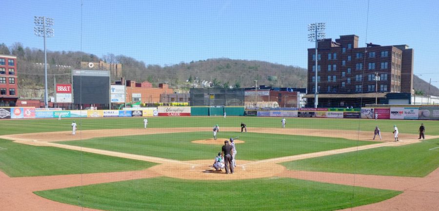 Marshall, sporting home white jerseys, plays defense as it attempts to stifle Florida Atlantic in game one of its Saturday afternoon doubleheader in Charleston, West Virginia. The Herd plays its C-USA matchups at Appalachian Power Park, which is also home of the Pittsburgh Pirates’ minor league affiliate, the West Virginia Power.