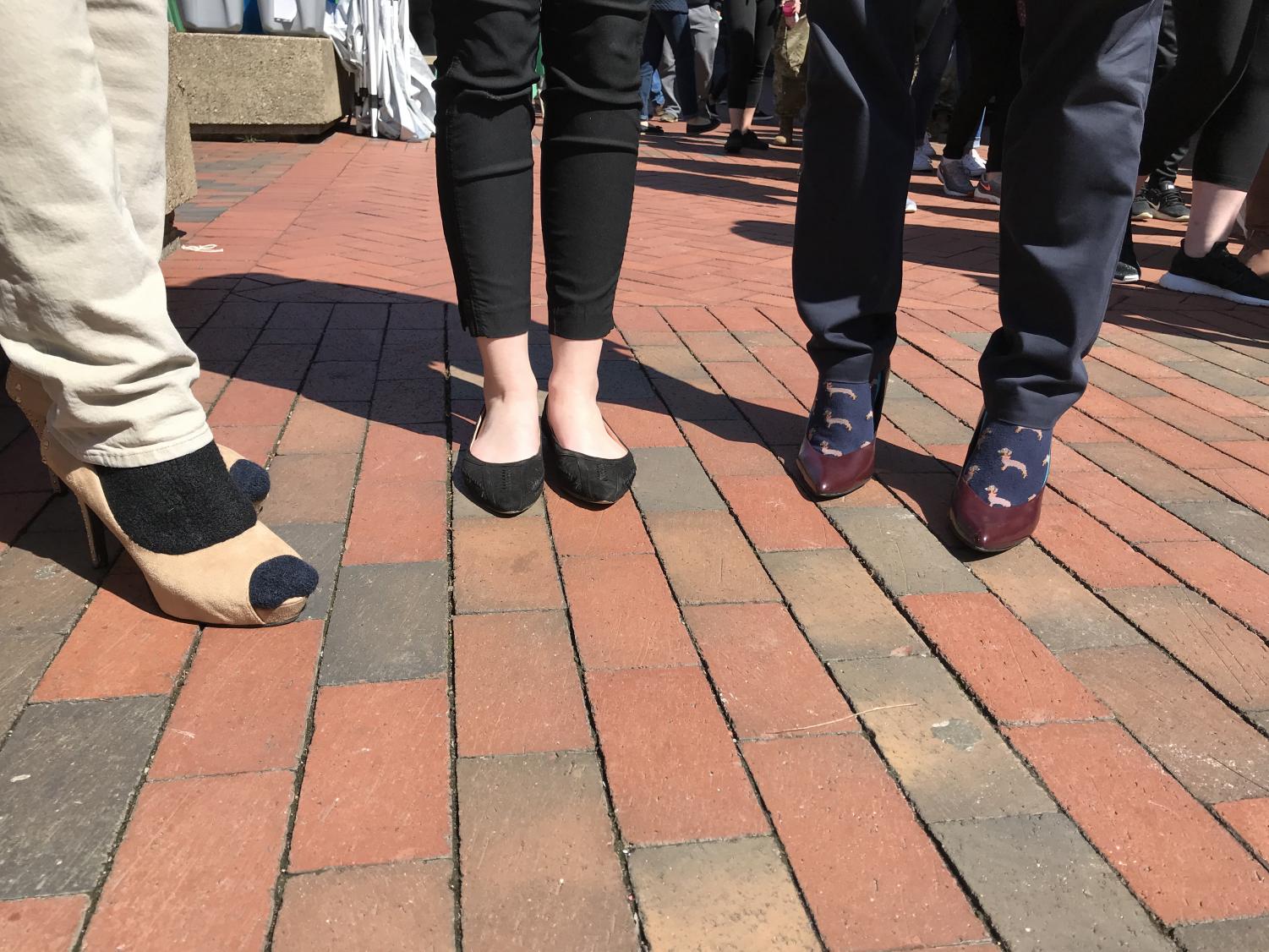 SGA President Matt Jarvis (Left), SGA Vice President-Elect Hannah Petracca (Middle) and Assistant Dean of Student Affairs Matt James show off their footwear for Walk a Mile in Her Shoes Thursday.
