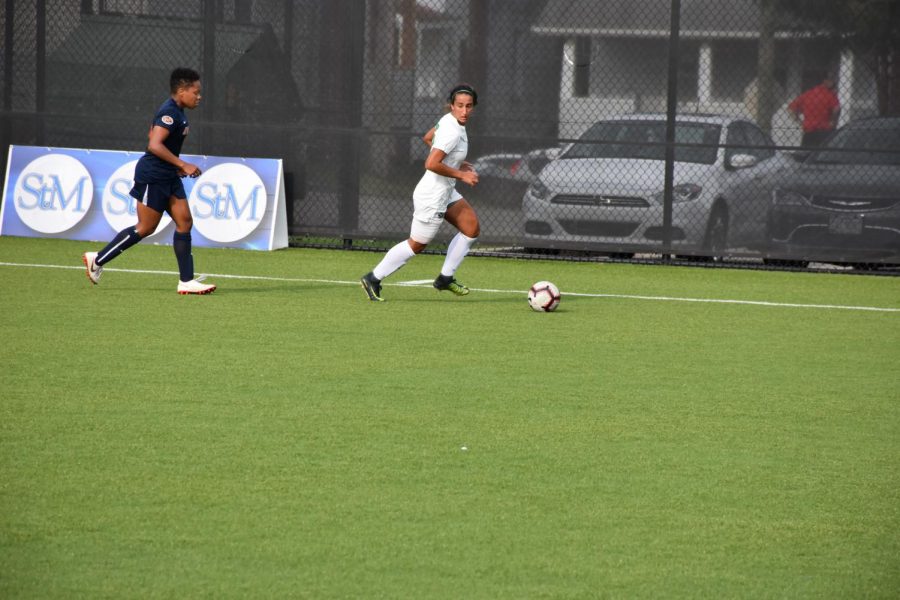 Junior forward Marah Abu-Tayeh avoids a Duquesne defender near the corner of the field.