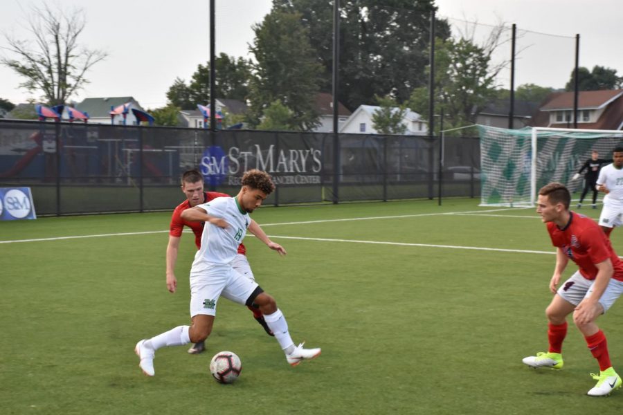 Freshman midfielder Charly Borges handles the ball around two Duquesne defenders. 