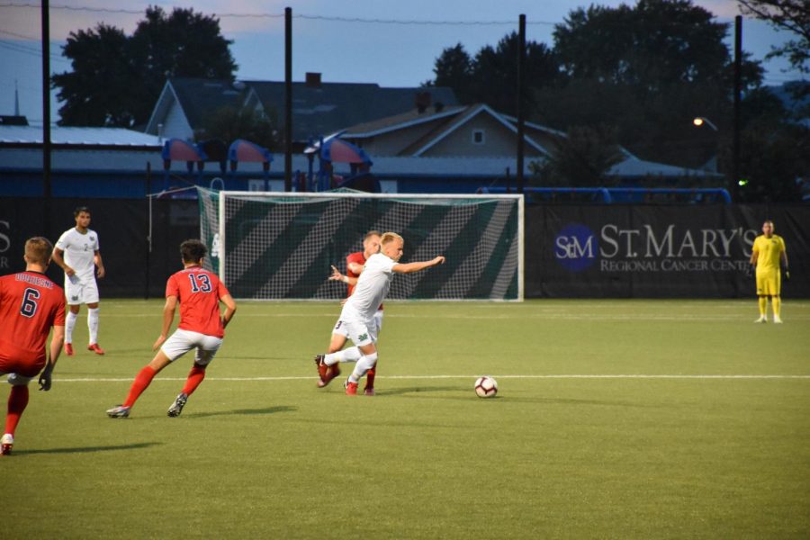 Senior midfielder Jonas Westmeyer breaks away from Duquesnes tackle attempts as he moves into the Dukes territory. 