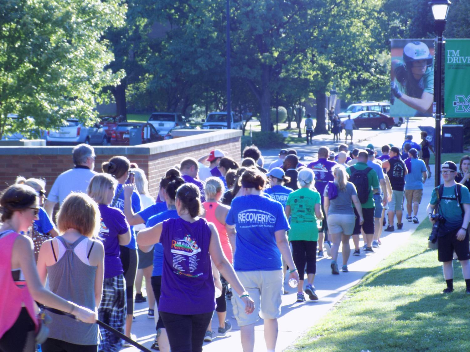 Community members walk during the Walk for Recovery event on Tuesday, September 4, 2018.