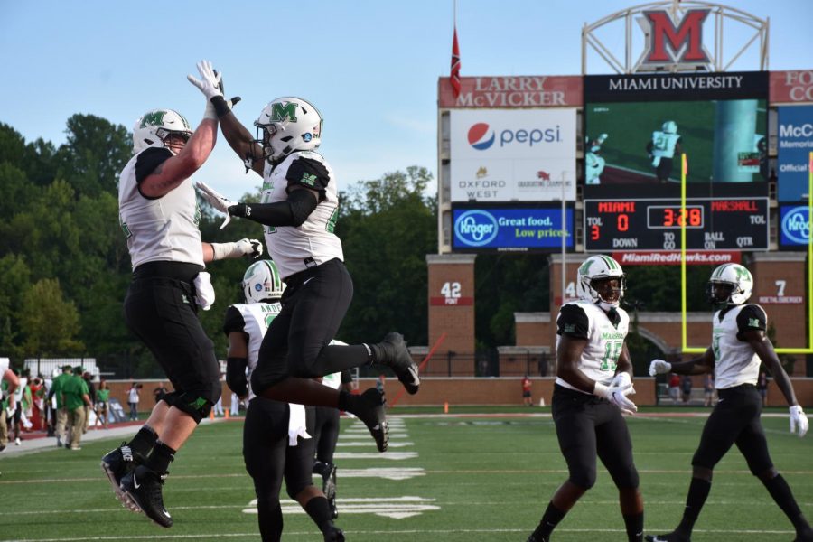 Redshirt junior offensive lineman Levi Brown and redshirt senior running back Keion Davis celebrate with high fives after the Herd takes a 14-0 lead over Miami in the first quarter. Davis and redshirt senior Anthony Anderson, combined to score three of Marshall’s five total touchdowns against the RedHawks.