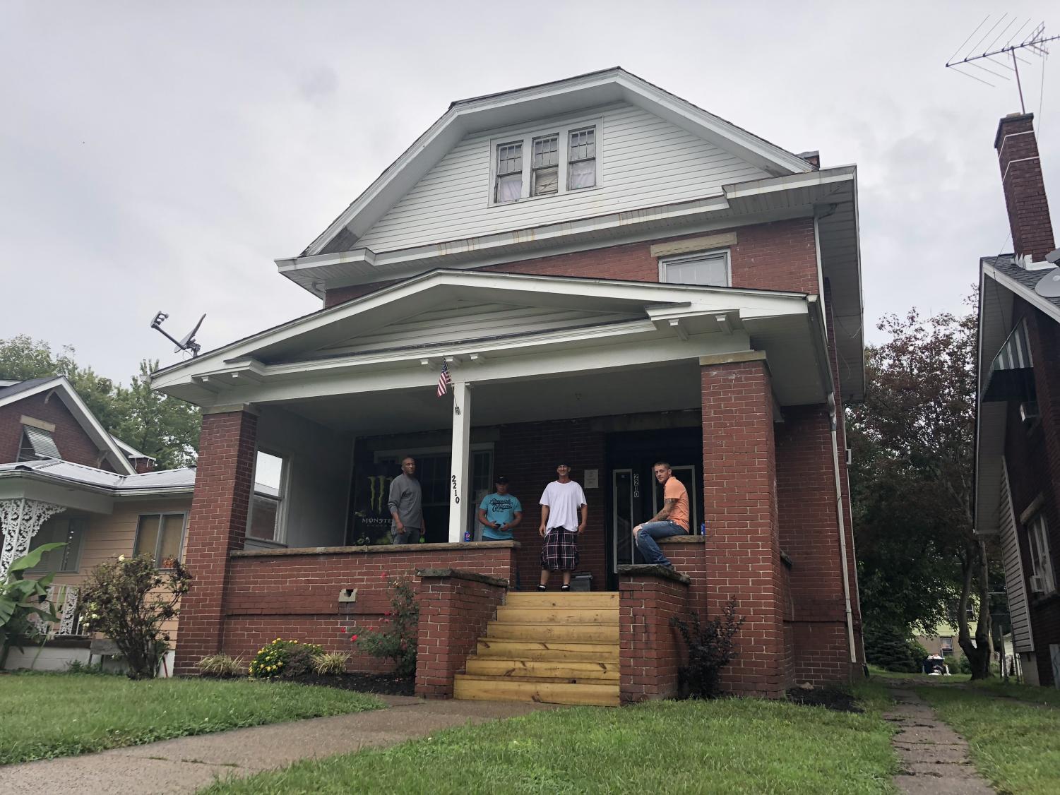 Thomas Anderson, Raymond Adkins, J.C. Musser and Joe Staley hang out on the porch of Newness of Life recovery center in Huntington.