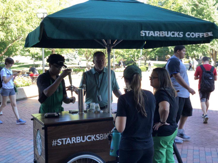 Starbucks employees serve samples of nitro cold brew coffee on the Memorial Student Center Plaza Sept. 14. 