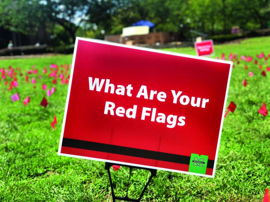 Red flags are set up on campus to represent the warning sign of violence in relationships.