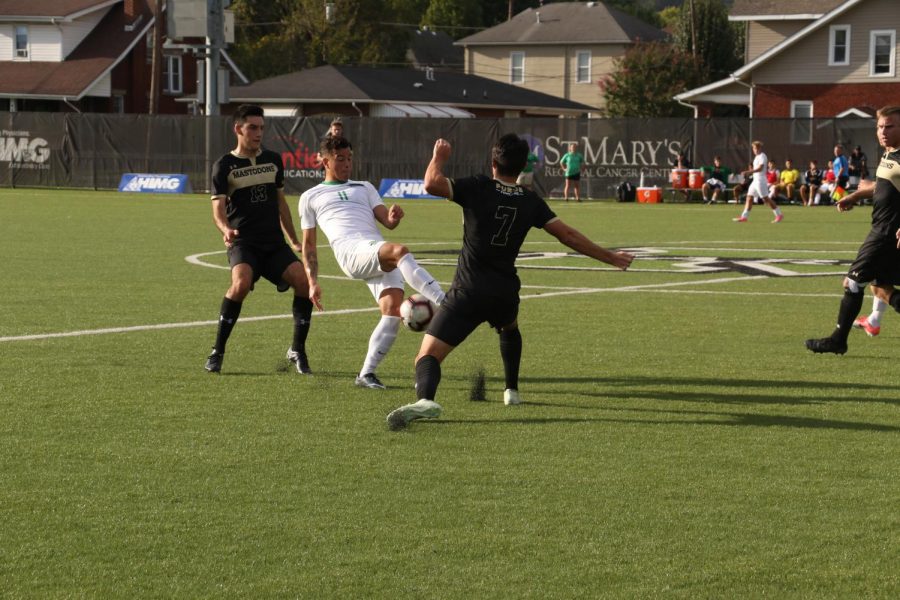 Marshall sophomore Jamil Roberts maneuvers around two defenders and attempts to advance the ball further into Purdue Fort Wayne territory.