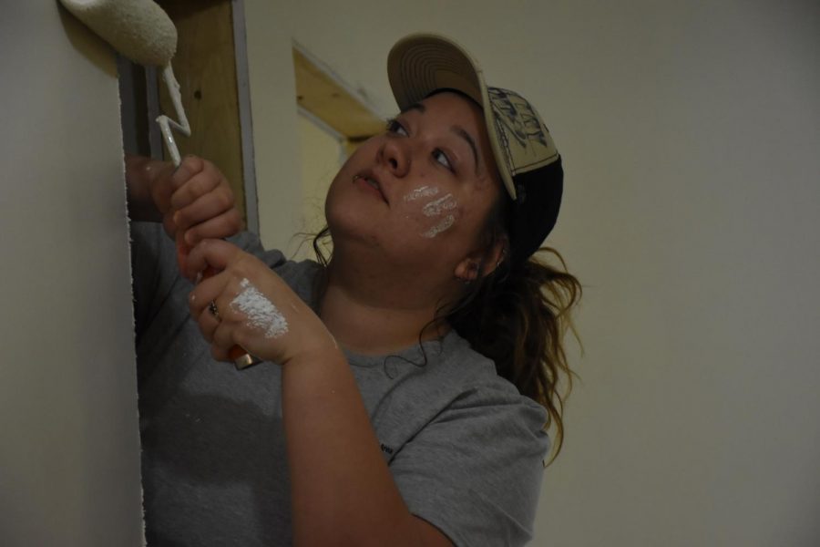 Cambria Farmer, president of Marshall University’s Habitat For Humanity, painting the door frame of one of the homes.