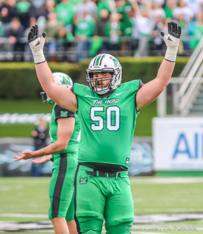 Redshirt sophomore offensive lineman Will Ulmer raises his arms in celebration after a Marshall score against FAU.