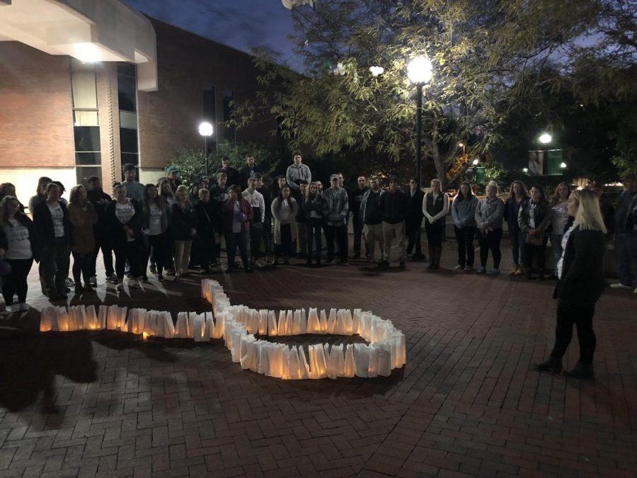 During+the+event+on+Thursday%2C+Oct.+25%2C+participants+walked+in+silence+around+the+Memorial+Student+Center+plaza+with+candlelit+bags+just+before+placing+them+in+the+form+of+a+ribbon+to+signify+domestic+violence+awareness.