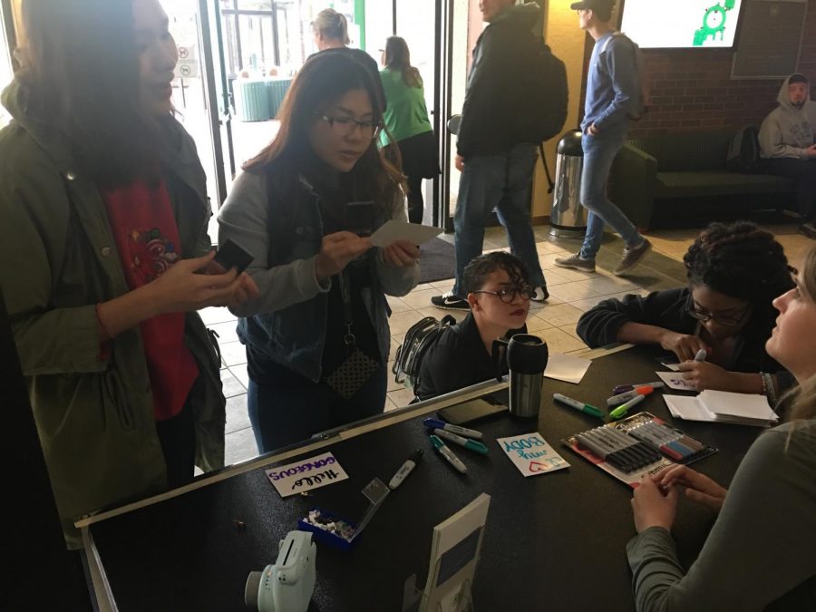 Students talk to Kailey Rigdon, graduate assistant at the Women and Gender Center, about negative self-image in the Memorial Student Center.