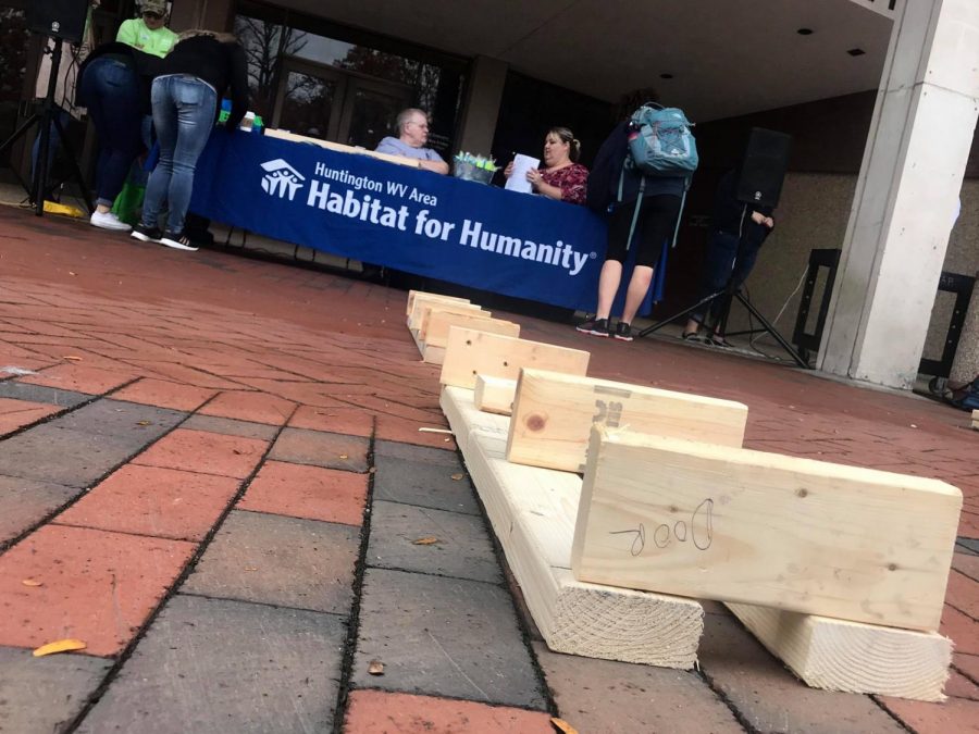 Marshall students assisted Habitat for Humanity in constructing a house by building a wall on the Memorial Student Center plaza.