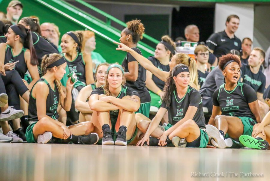 Marshall women’s basketball team sits and watches the dunk contest in the Henderson Center at “Herd Madness.”
