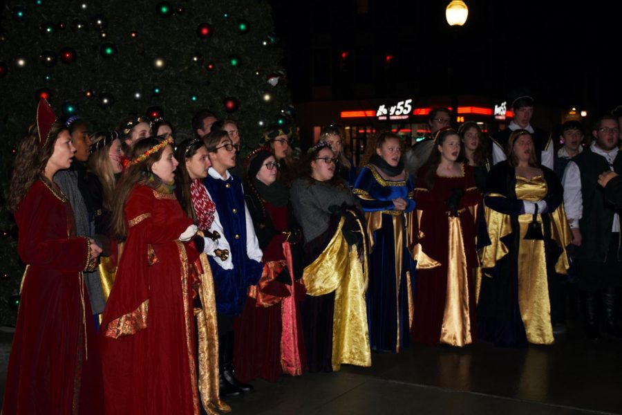 The Huntington community listens to the Cabell Midland High School Collegium Musicum during the annual tree lighting in front of the Big Sandy Superstore Arena on Nov. 27.