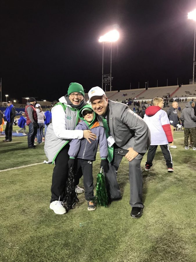 Kim Corriher, Gaffney Corriher and Jason Corriher (left-to-right) stand on the field of Dreamstyle Stadium after Marshall’s 31-28 defeat of Colorado State in the Gildan New Mexico Bowl.