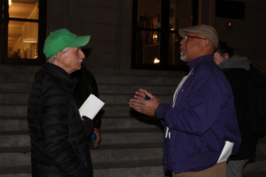 Huntington resident Mark Connelly talks with Damon Core, an executive board member of SEIU 1199, about the hospital board deal ordinance outside the Huntington City Council meeting.