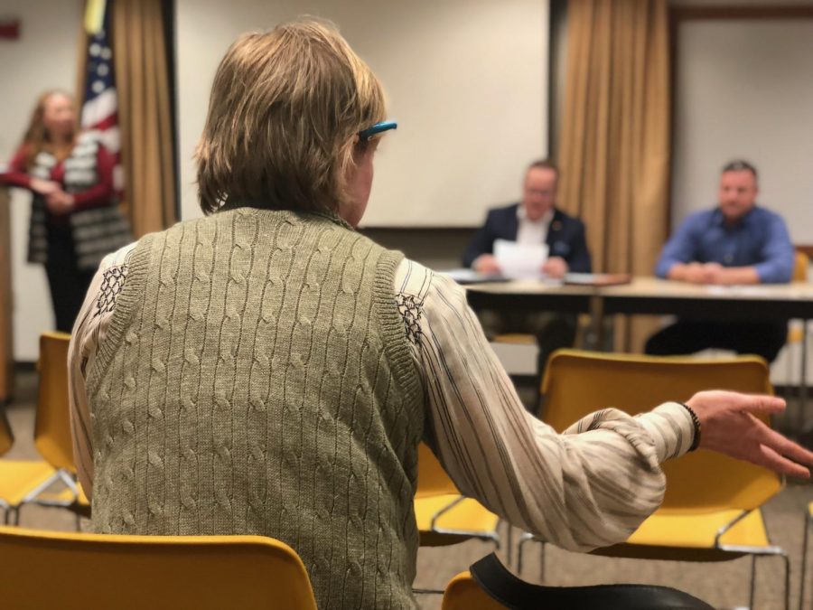 Local parent, Jill LaFear, looks on as Delegate Matthew Rohrbach (R- Cabell, 17), Delegate Chad Lovejoy (D- Cabell, 17) and Delegate John Mandt (R- Cabell, 16) read through and discuss Senate Bill 451 during a town hall meeting Feb. 16 at the Cabell County Public Library in Huntington.