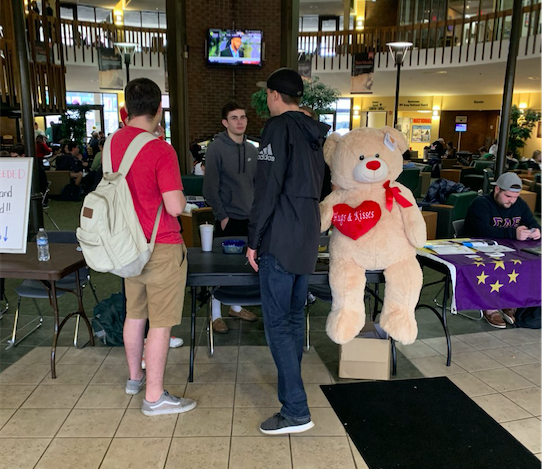 Members of Alpha Tau Omega advertise the Valentines Day Raffle Wednesday in the Student Center.