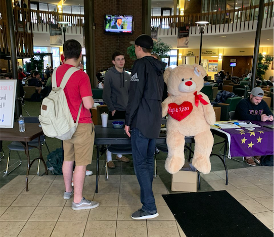 Members of Alpha Tau Omega advertise the "Valentine's Day Raffle" Wednesday in the Student Center.