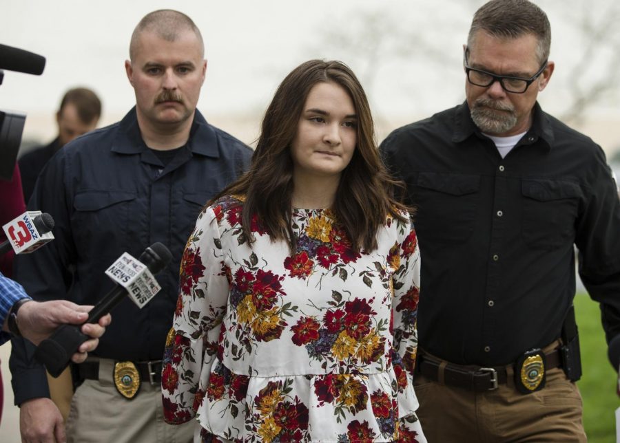 Santana Renee Adams is escorted into Cabell County Magistrate Court to be arraigned on charges for falsely reporting an emergency incident, Friday, April 5, 2019, in Huntington, W.Va. The charges stem from Adams falsely reporting that an Egyptian man attempted to kidnap her daughter from a West Virginia shopping mall Monday evening.