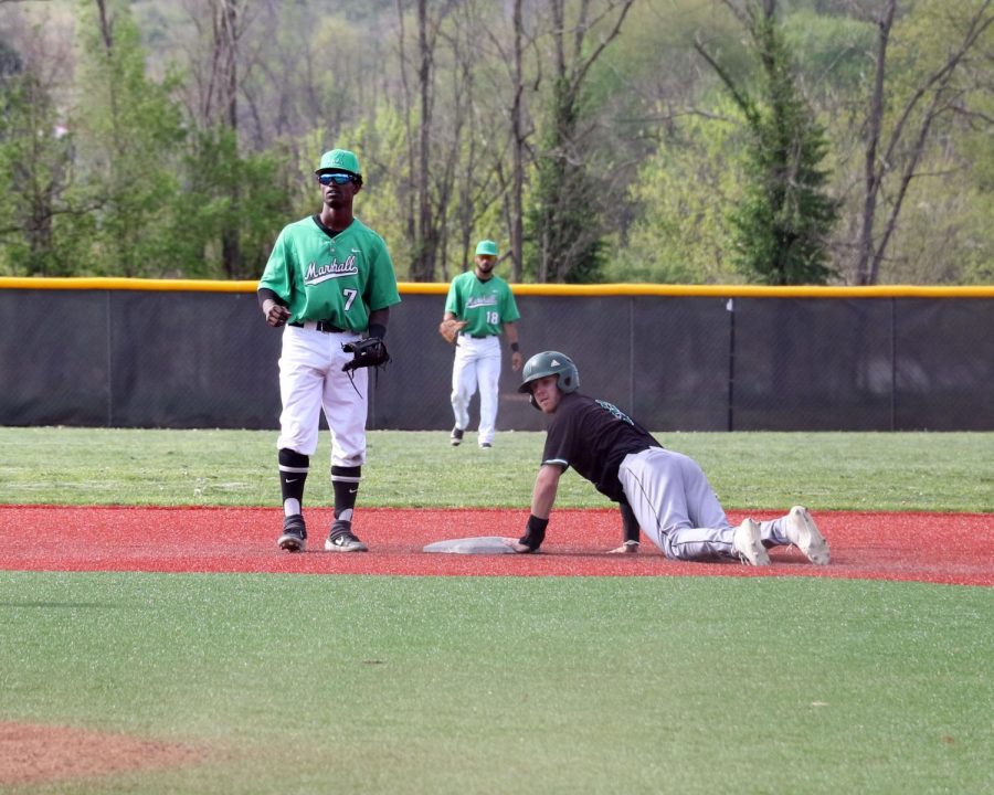 Marshall shortstop Elvis Peralta (7) watches as Ohio center fielder Michael Richardson slides into second base during the teams’ midweek matchup at the Kennedy Center Field, April 16, 2019.