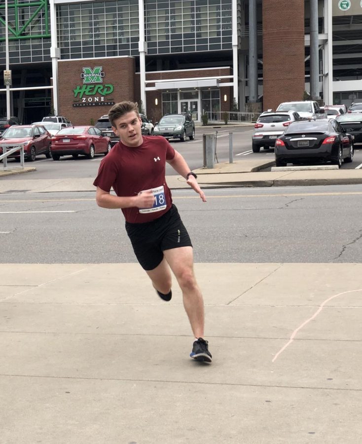 Jeremiah Parlock, a junior political science major and member of the Student Government Association, rounds the last bend of the We Will Run For You 5K route. Parlock was the second runner to finish the race.