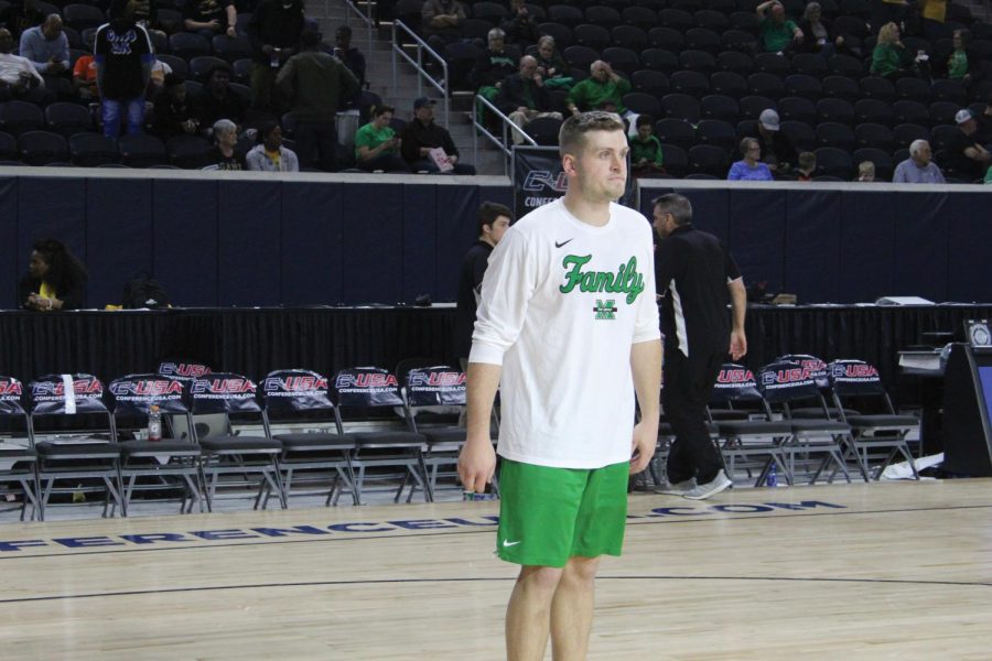 Marshall men’s basketball co-head manager Danny Feck prepares to rebound a shot from one of the Herd’s players during warmups prior to a Conference USA Tournament game against Southern Miss on March 14.