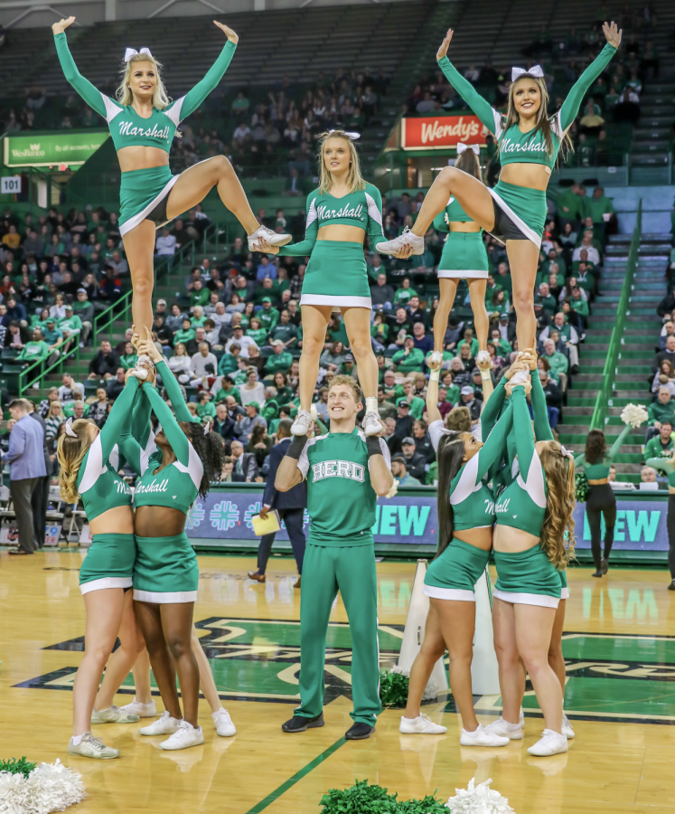 Marshall cheerleaders pose in a stunt before the men’s basketball game versus UTEP on Jan. 31 in the Cam Henderson Center.