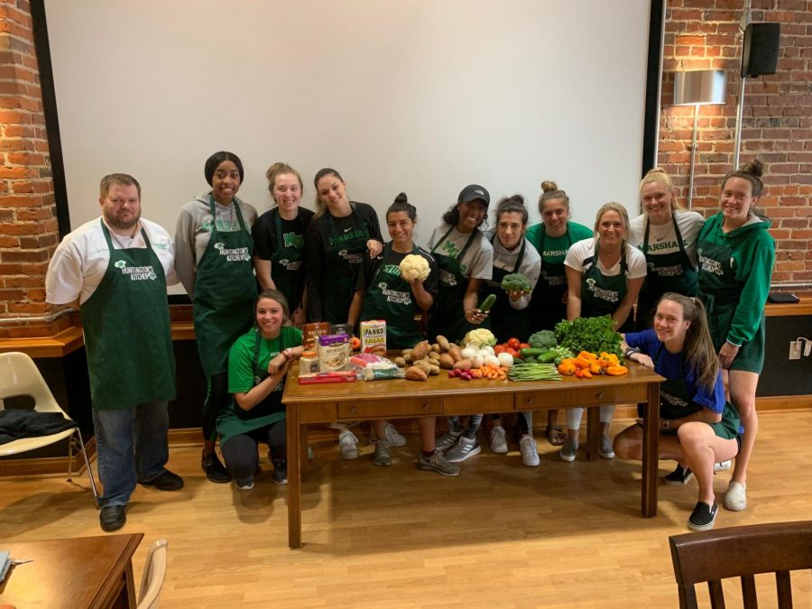 The+Marshall+volleyball+team+poses+for+a+photo+with+chef+Marty+Emerson+at+Huntingtons+Kitchen+April+5%2C+2019.+The+team+participated+in+an+Iron+Chef+competition+as+a+means+of+team-building.