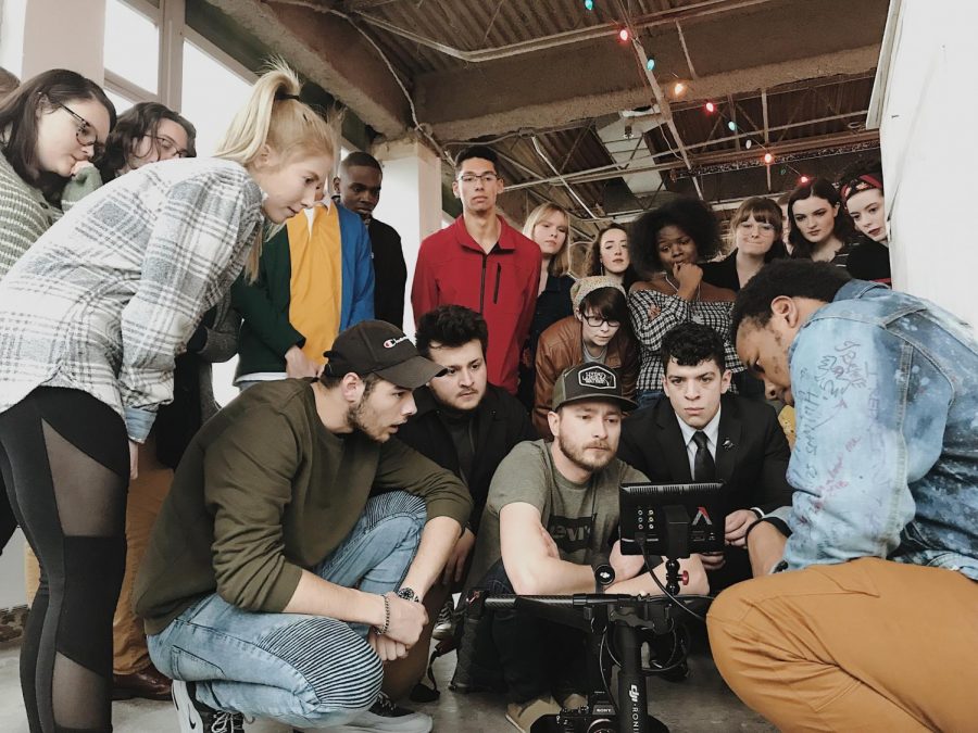 “Wake Up Dorothy” production team members gather around camera to make group decision.