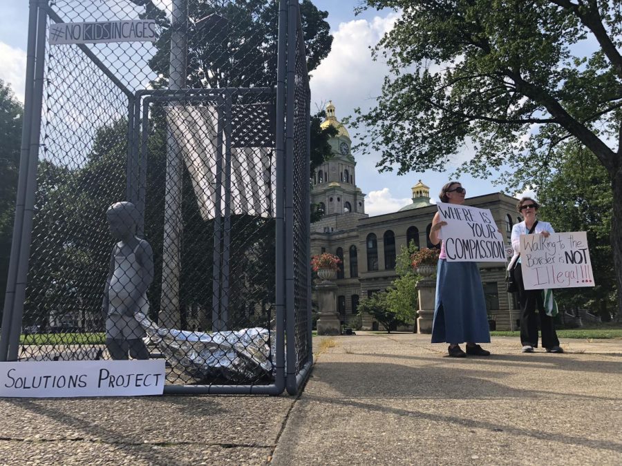 Local activists protest U.S. border conditions, Thursday evening outside the Cabell County Courthouse. Sculpture was created by local artist, David McGee.