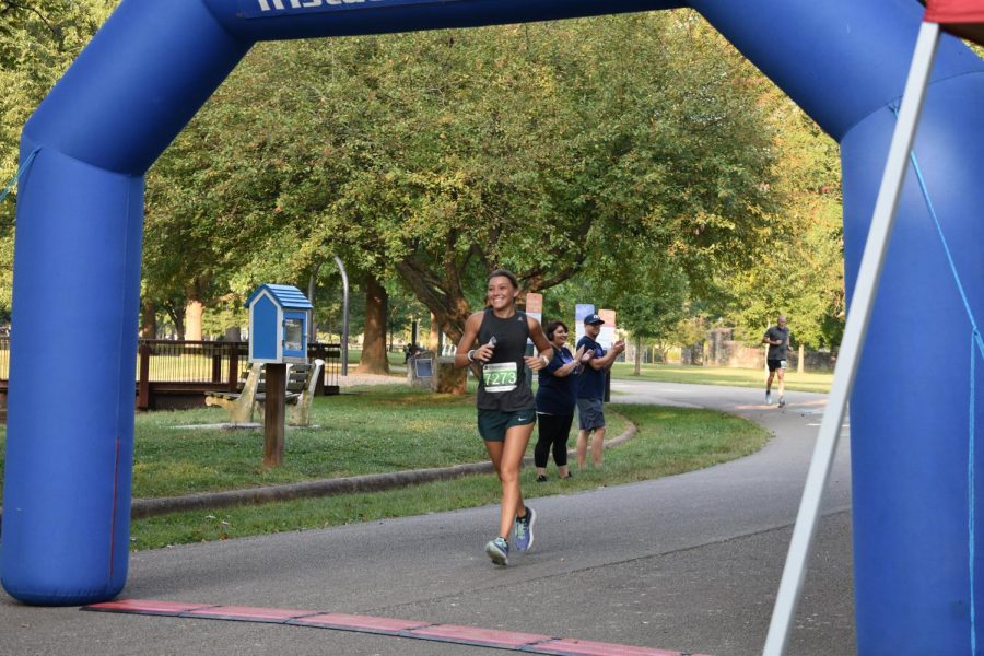 Local community member Alisha Harbour flashes a smile Saturday at Ritter Park just before completing Encouraging Every Step to Recovery 5k.