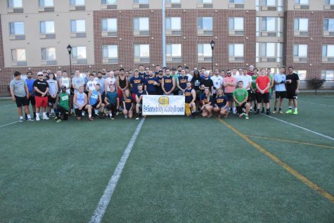 All the family, friends and football participants stand together to honor Brown.