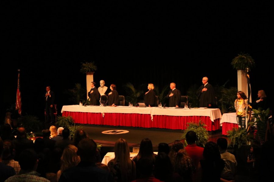 West Virginia Supreme Court Justice Evan H. Jenkins, Justice Margaret L. Workman, Chief Justice Elizabeth D. Walker, Justice Tim Armstead and Justice John A. Hutchinson pledge allegiance to the U.S. flag while meeting at the Joan C. Edwards Performing Arts Center to hear cases in front of a group of students and community members Sept. 11, 2019.