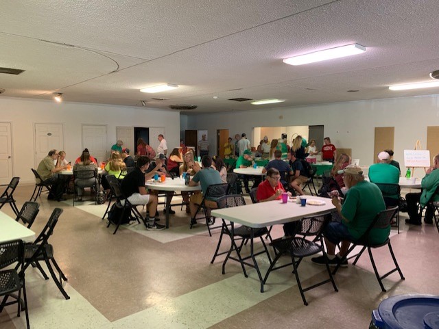 Members of the Marshall and Huntington communities eat food provided by Highlawn Presbyterian Church during Lunch for a Buck event Tuesday, Sept. 9. 