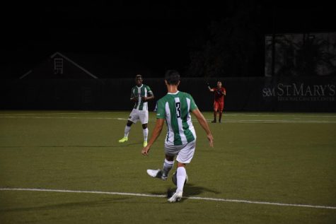 Carlos Diaz- Salcedo passes the ball to teammate Illal Osmanu; goalkeeper Paulo Pita is in the background.